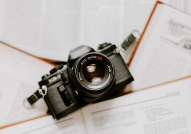 black nikon dslr camera on white printer paper