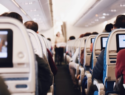 shallow focus photography of people inside of passenger plane