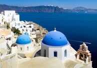 white and blue dome building near body of water during daytime
