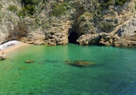 a body of water with a cave in the middle of it